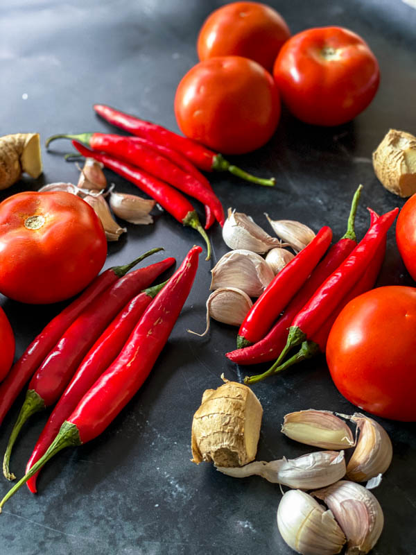 A few of the ingredients - tomatoes, chillies, garlic and ginger on the bench.