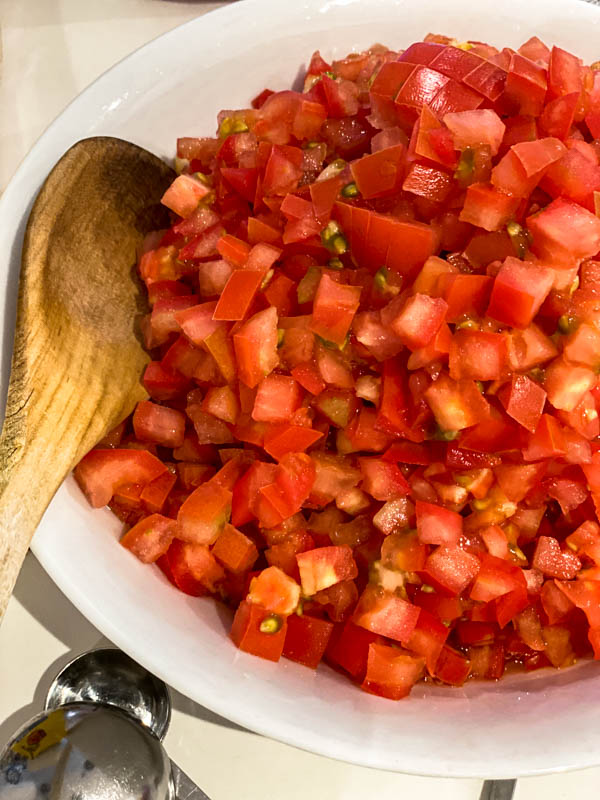 Looking down onto the bowl of chopped tomatoes.