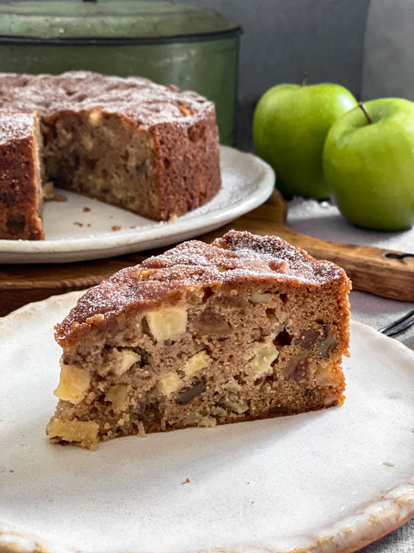 A close up of a slice of the Apple Fig and Walnut Cake.