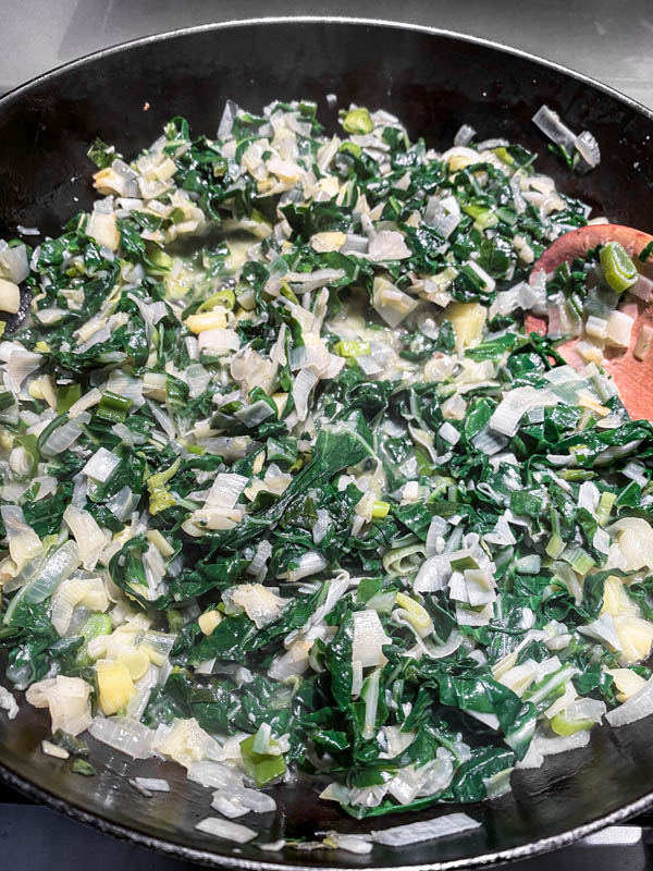 The onions, leeks and silverbeet have now been cooked and wilted down in the pan.