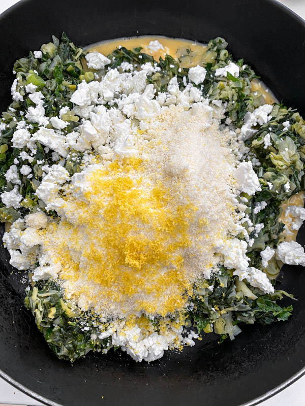 The 3 cheeses (ricotta, feta and parmesan), lemon zest and nutmeg are now added to the silverbeet mixture along with the eggs.