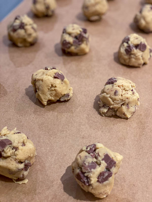 A close-up of the roughly shaped balls of cookie dough ready to be baked.