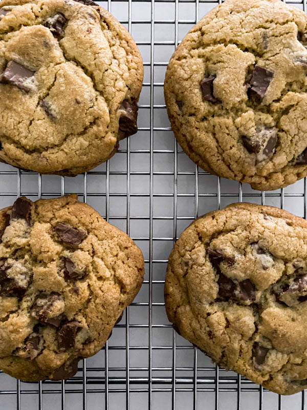 A close-up of the 4 baked cookies showing chunks of chocolate throughout.