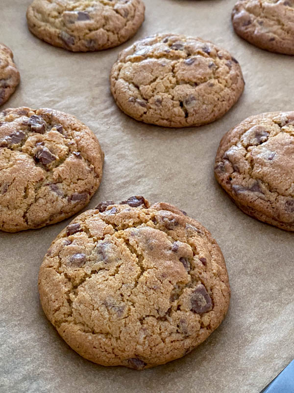 The Chocolate Chip Cookies are cooked and resting on the oven tray until completely cooled.