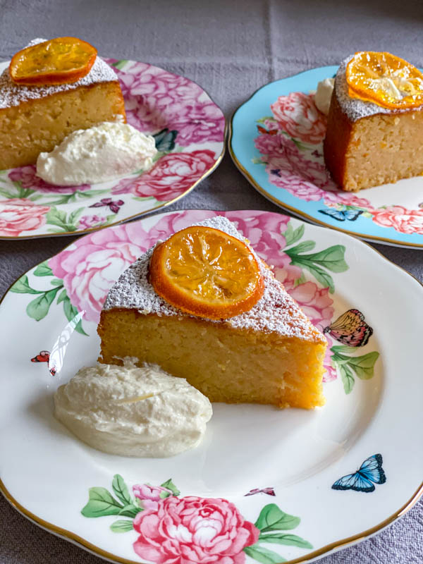 The lemon cake slices are on floral china cake plates.