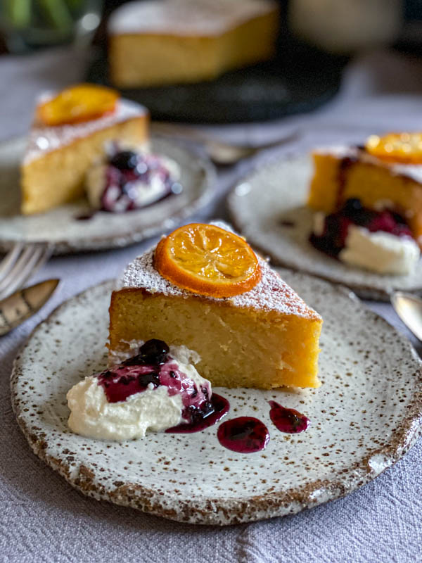 The lemon cake slices are served with a dollop of yoghurt and a good drizzle of blueberry and thyme compote.