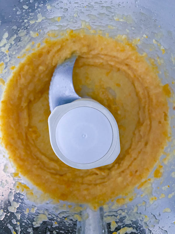 Looking into the food processor bowl at the lemon puree.