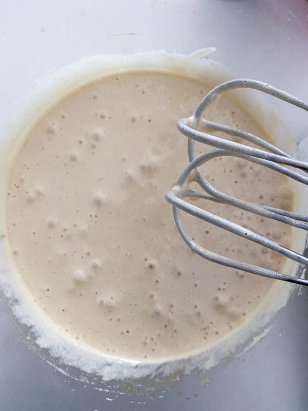 The eggs and sugars are now beaten together to form a thick and creamy mixture.