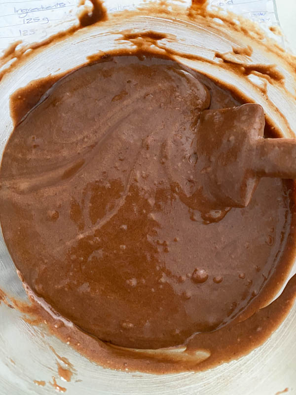 The dry and wet ingredients are now combined to form the brownie batter shown here in the glass bowl.