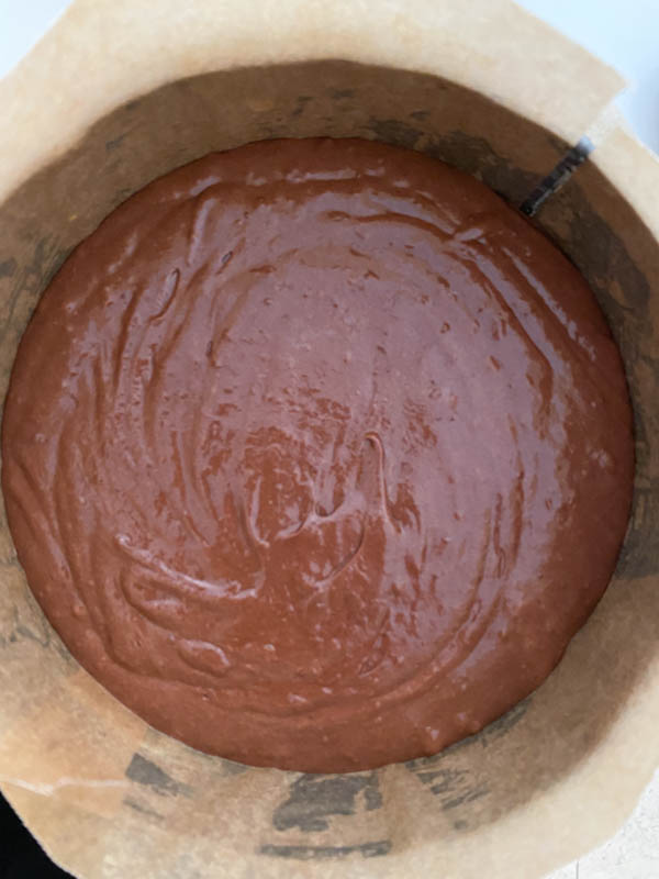 The brownie batter is now in the round baking tin which has been lined with baking paper.