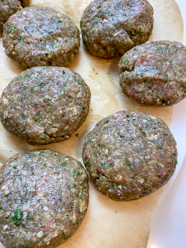 A close-up of raw kofta patties that have been shaped.