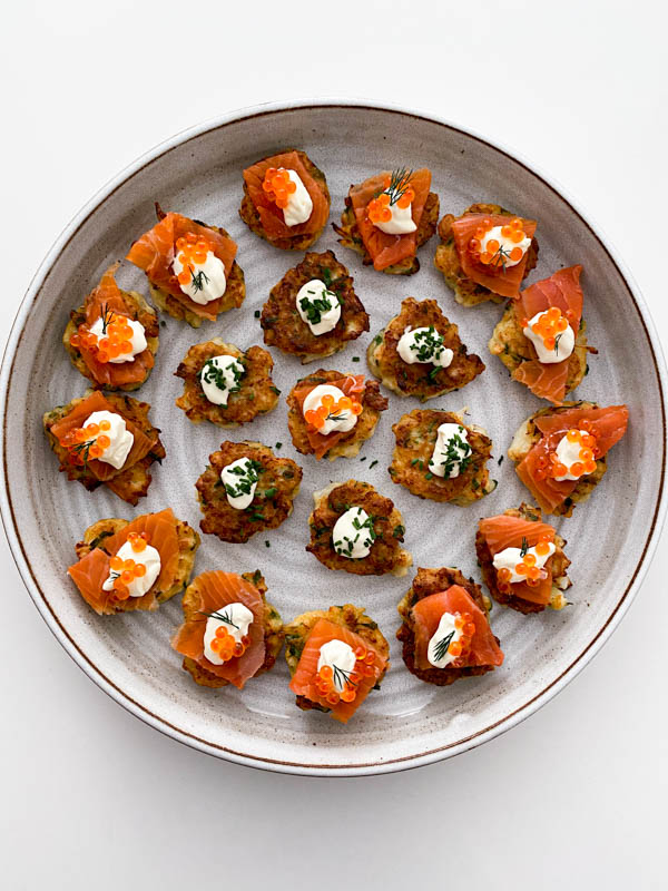 Looking down onto a round platter filled with Cauliflower Fritters ready to be served.