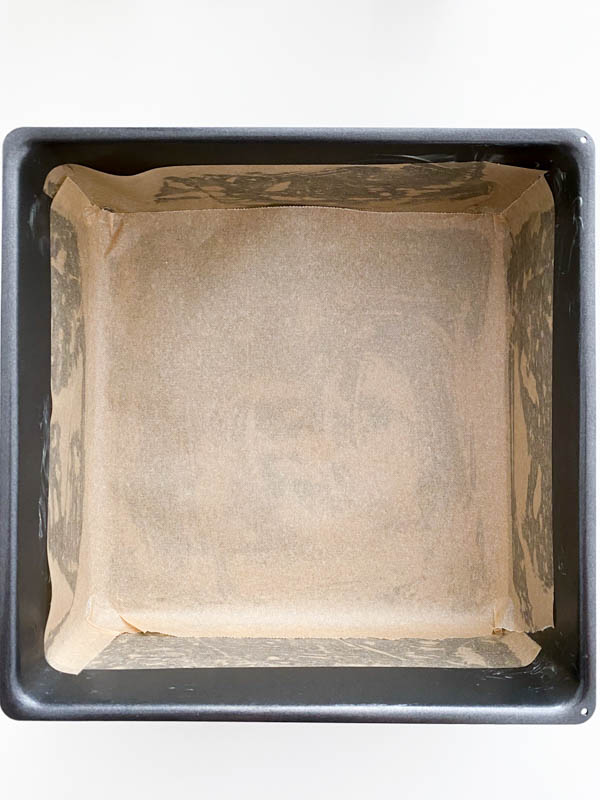 The baking tin is shown here greased and lined with baking paper.