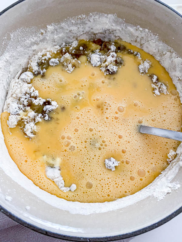 The lightly beaten eggs have now been added to the mixture in the pot and will be stirred through.