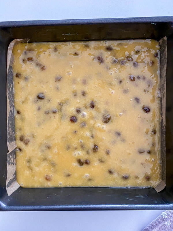 Looking down onto the 22cm square cake tin that is filled with the cake batter, ready to be baked.