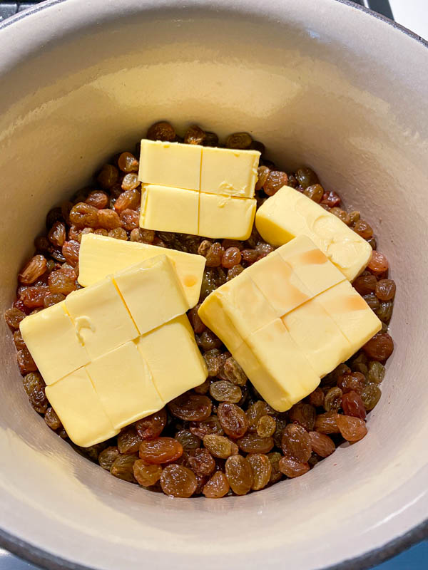 The sultanas are in the pot and are plump after being boiled. The butter has now been added.