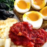 A cooked breakfast plate featuring the Breakfast Tomatoes.