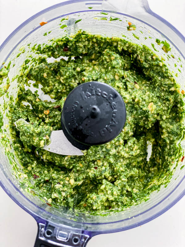 Looking down into the mini food processor bowl showing the Thai Basil pesto.