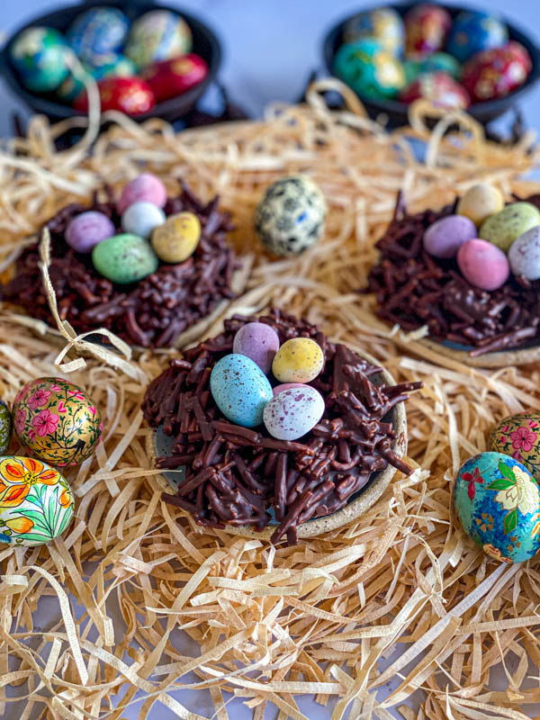 Here the Easter Chocolate Nests are placed on top of straw. They are filled with mini easter eggs with some small decorative easter eggs around them.