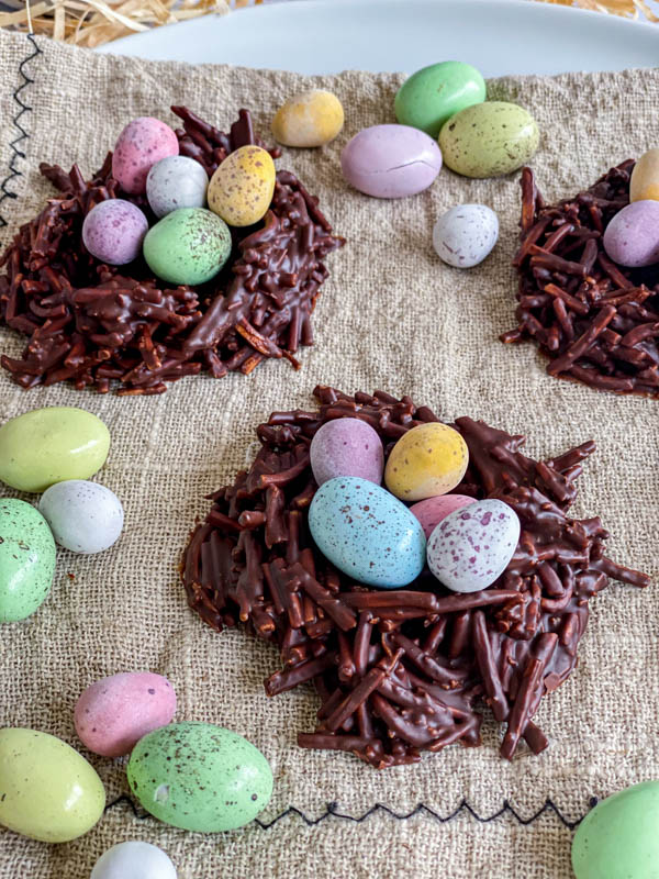 A close up of one of the chocolate nests filled with coloured mini easter eggs.