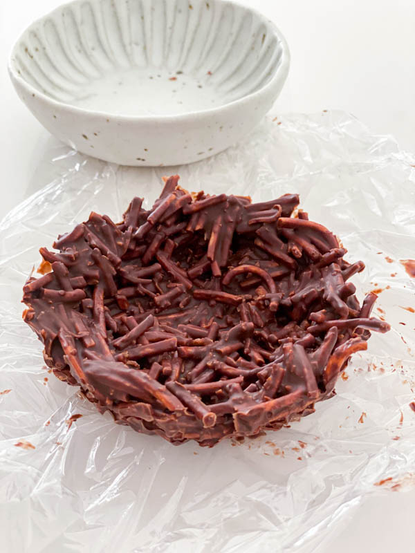 The set chocolate nest is removed from the small bowl once it has fully set in the fridge.