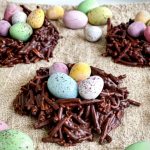 The Easter Chocolate Nests are filled with mini easter eggs and are on a plate plate ready to be served.