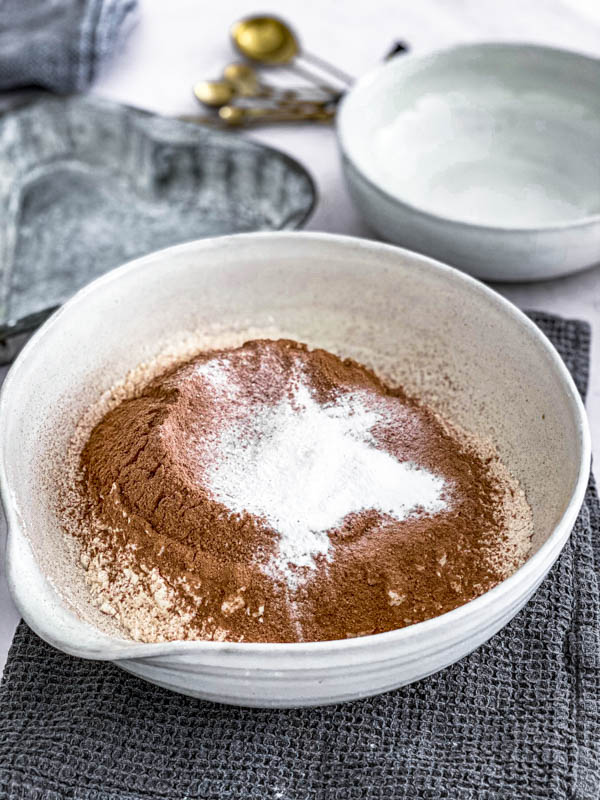 The dry ingredients are sifted into a bowl.