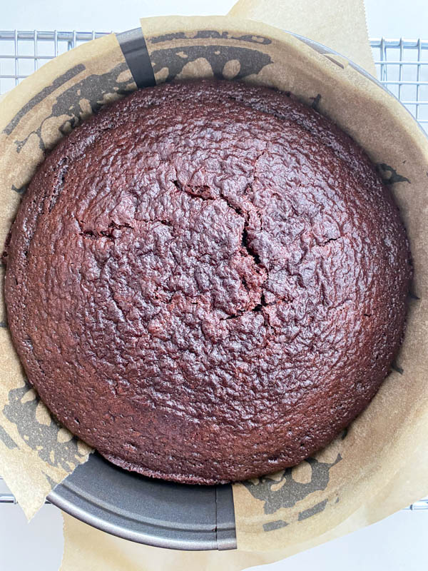 The baked cake is resting in the tin.