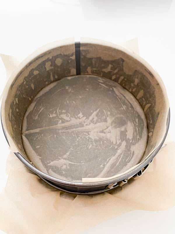 A springform round tin is greased and lined with baking paper.