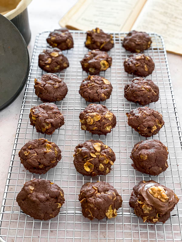 The Afghan Biscuits are cooling on a wire cooling rack.