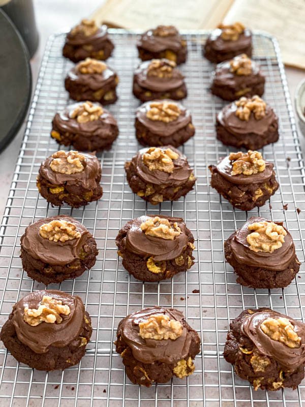 All the Anzac Biscuits are now iced with chocolate icing and topped with walnuts.