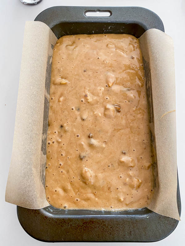 The batter is in a loaf tin ready to be baked, showing that this recipe can also be made into a loaf as well as muffins.