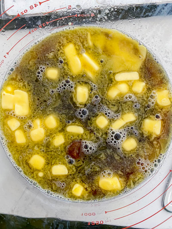 Boiling water is added to the butter, dates and sugar in a large mixing bowl.