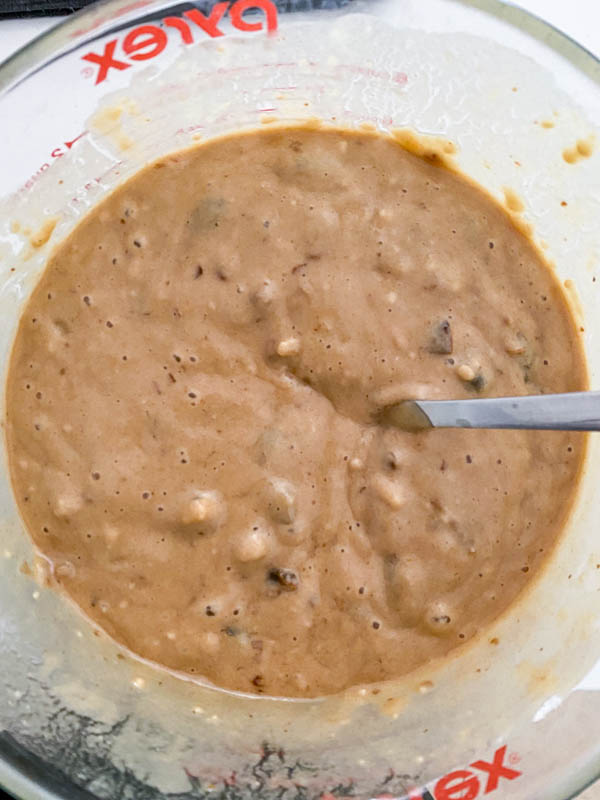 The muffin batter is all mixed together ready to be spooned into muffin tins or a loaf tin.