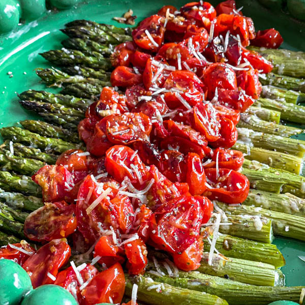 The salad is ready to be served on a round green platter.