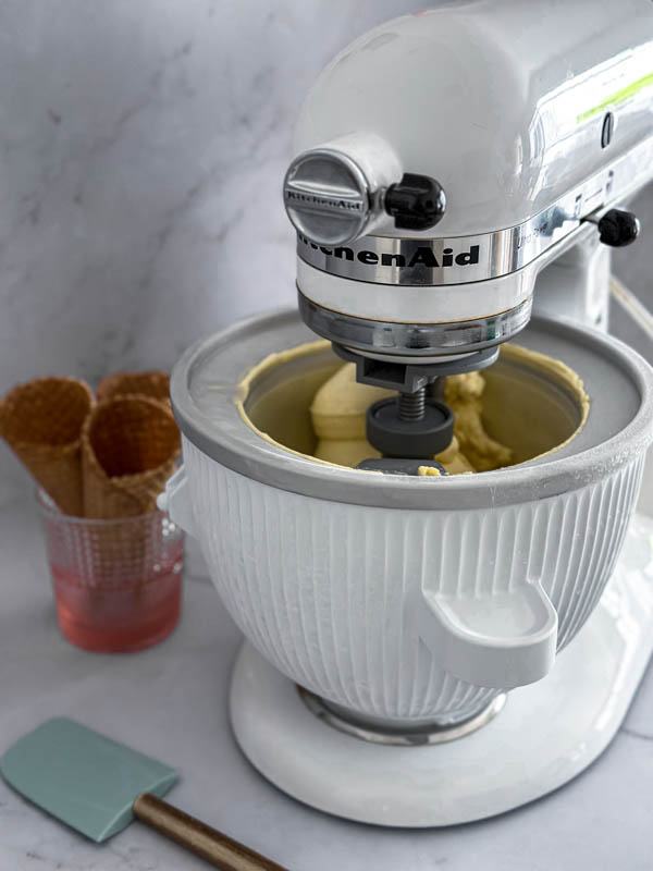 The ice cream is churning in a KitchenAid Ice Cream Maker attachment. It is almost ready.
