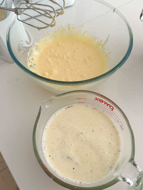 The infused vanilla cream mixture is in a jug ready to be added to the egg mixture.