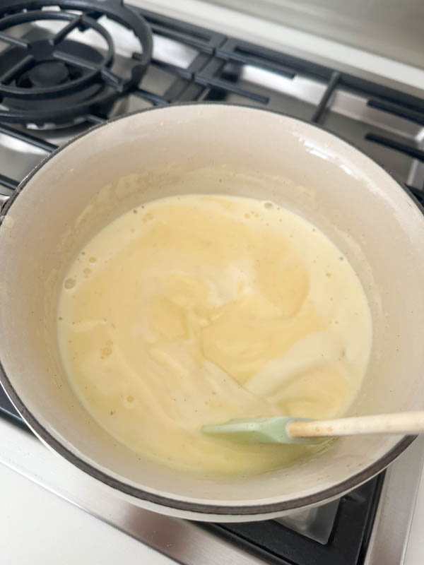 The custard base in now in a pot cooking over a low heat while being stirred constantly.